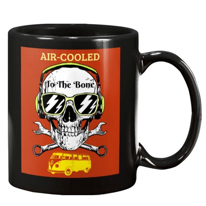 This is an image of an 11oz black coffee mug with a skull in sunglasses and headphones with wrenches crossed like skull and crossbones and a red background with a yellow VW bus at the bottom and the phrase  AIR-COOLED  To The Bone